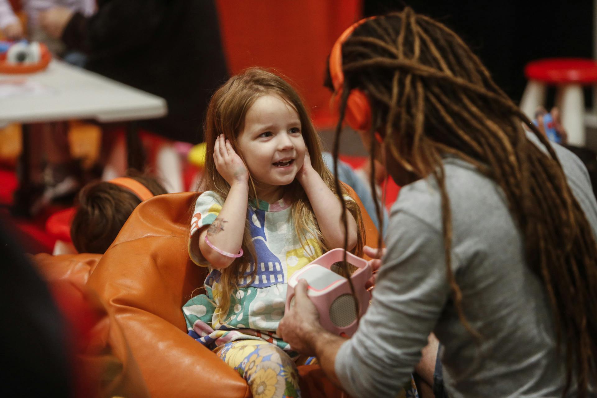A kid on a beanbag chair about to listen to something on a Yoto Player