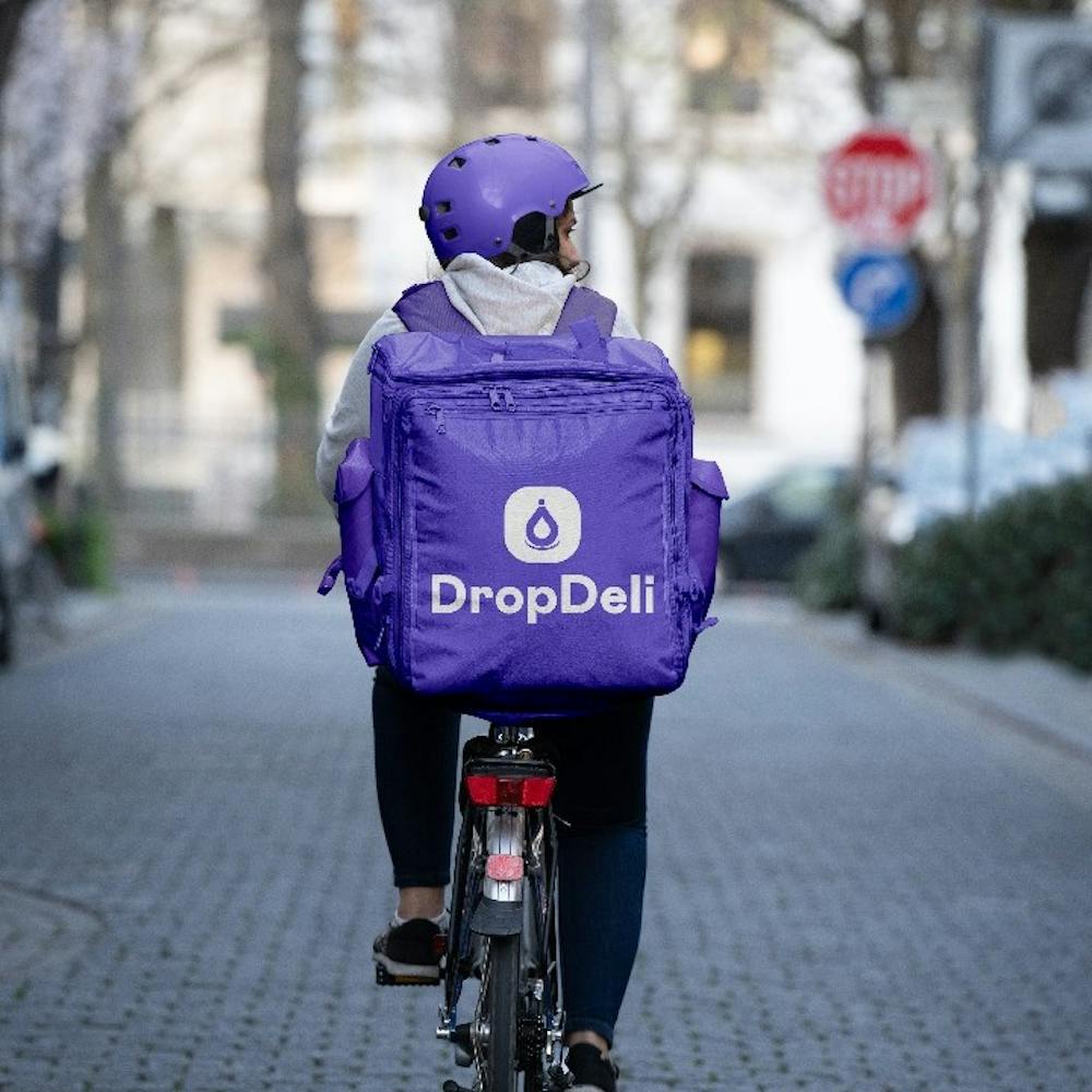 Delivery rider with a DropDeli bag