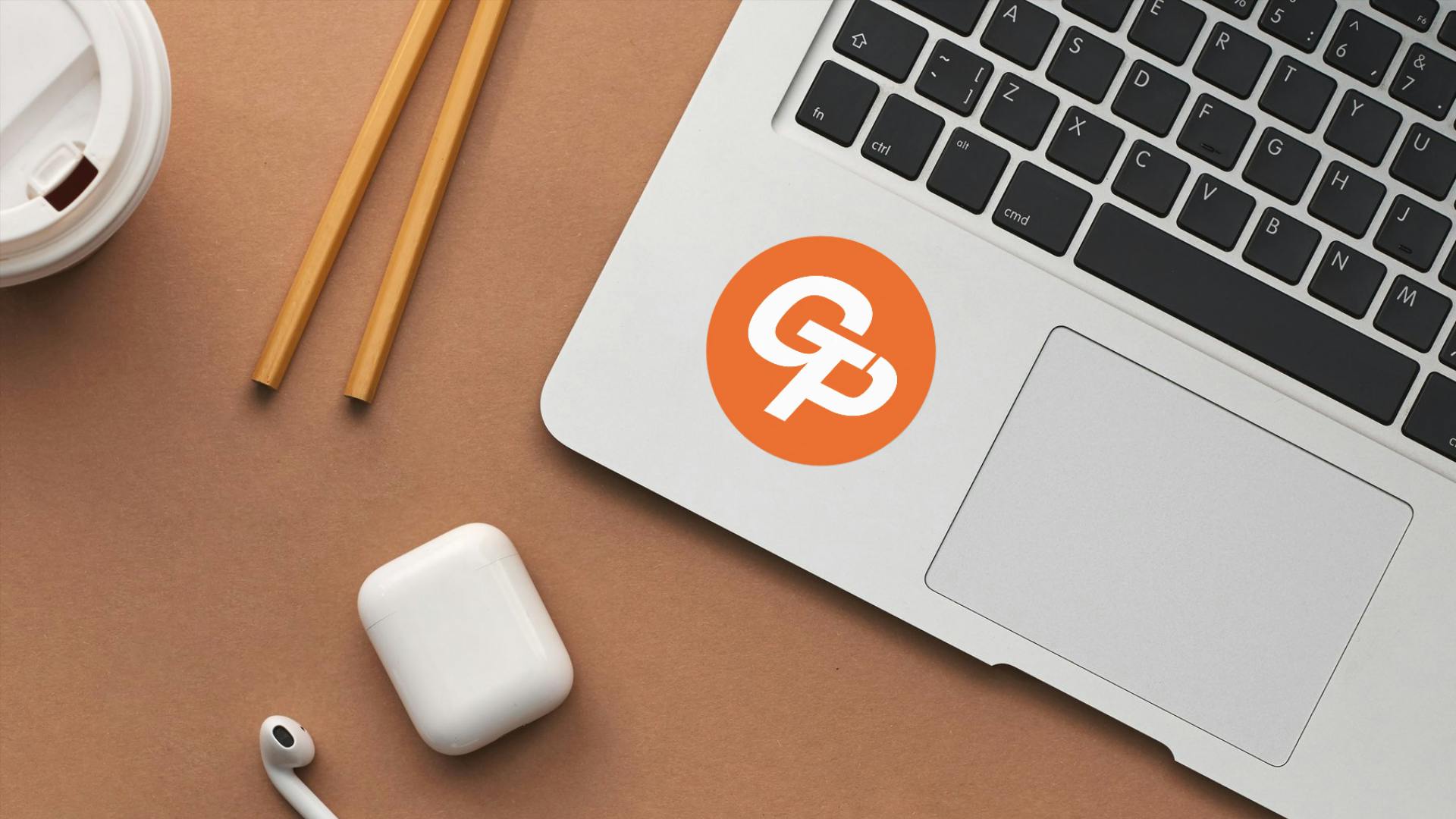 커피 한 잔 옆에 오렌지 로고가있는 노트북