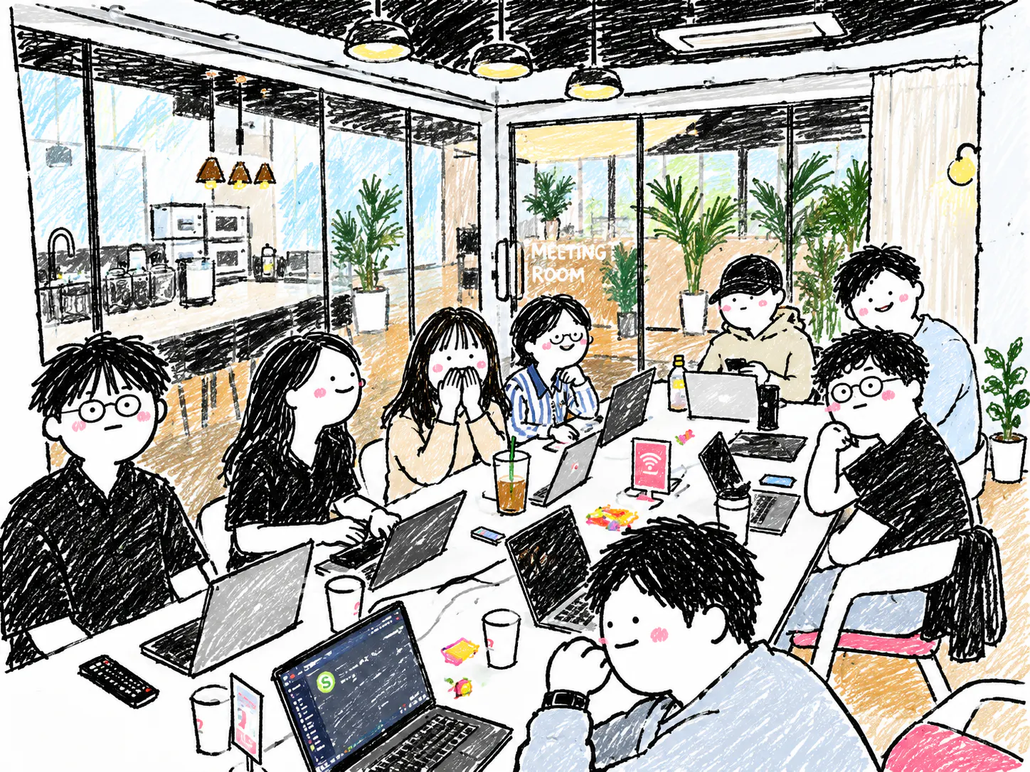 노트북을 들고 테이블 주위에 앉아 있는 한 무리의 사람들