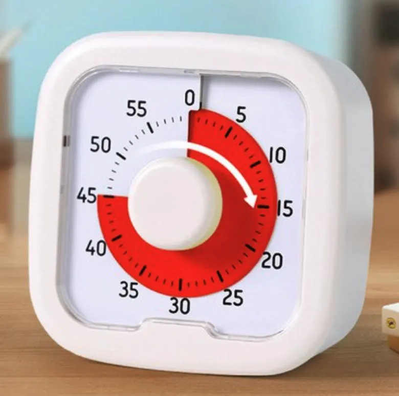 테이블에 앉아있는 흰색과 빨간 타이머