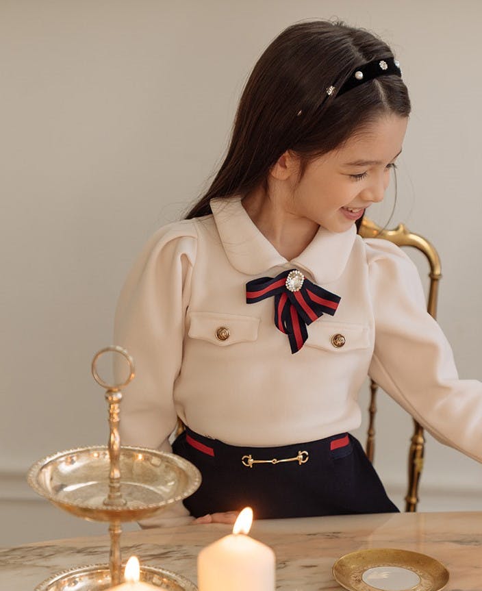 촛불이 달린 테이블에 앉아 어린 소녀