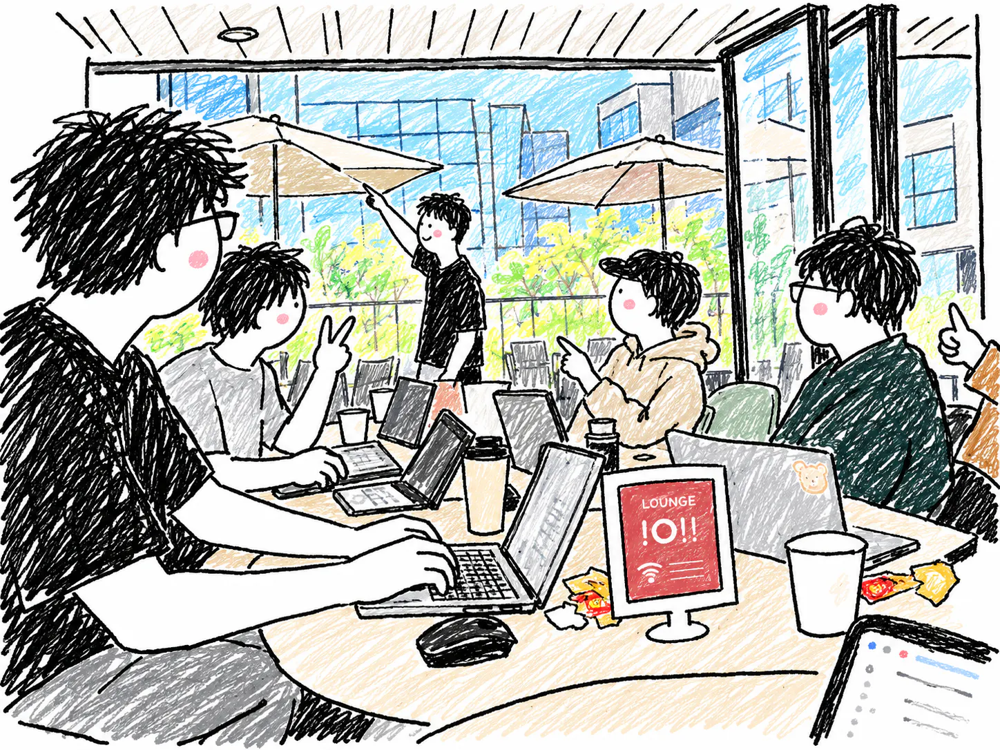 노트북을 들고 테이블에 앉아 있는 한 무리의 사람들